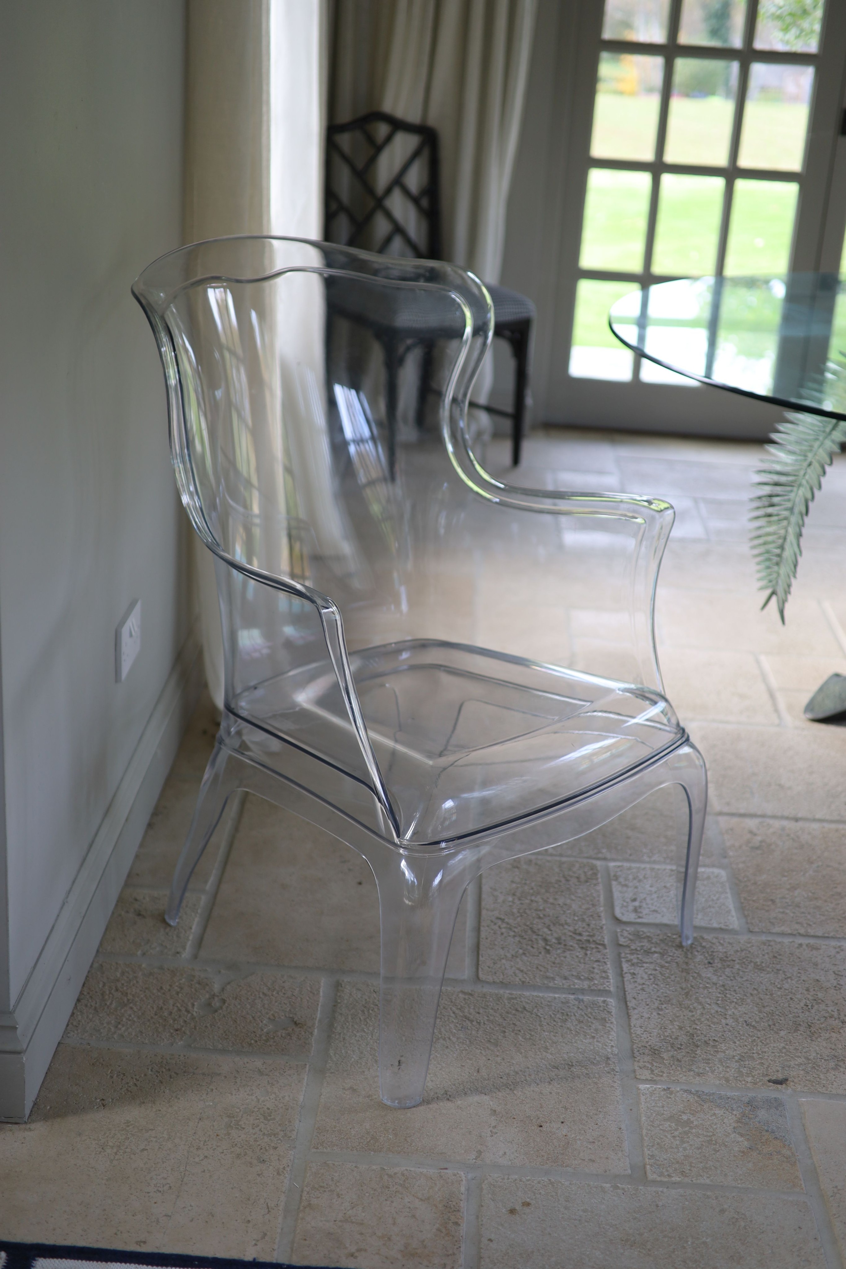 A perspex ghost chair, width 71cm height 98cm